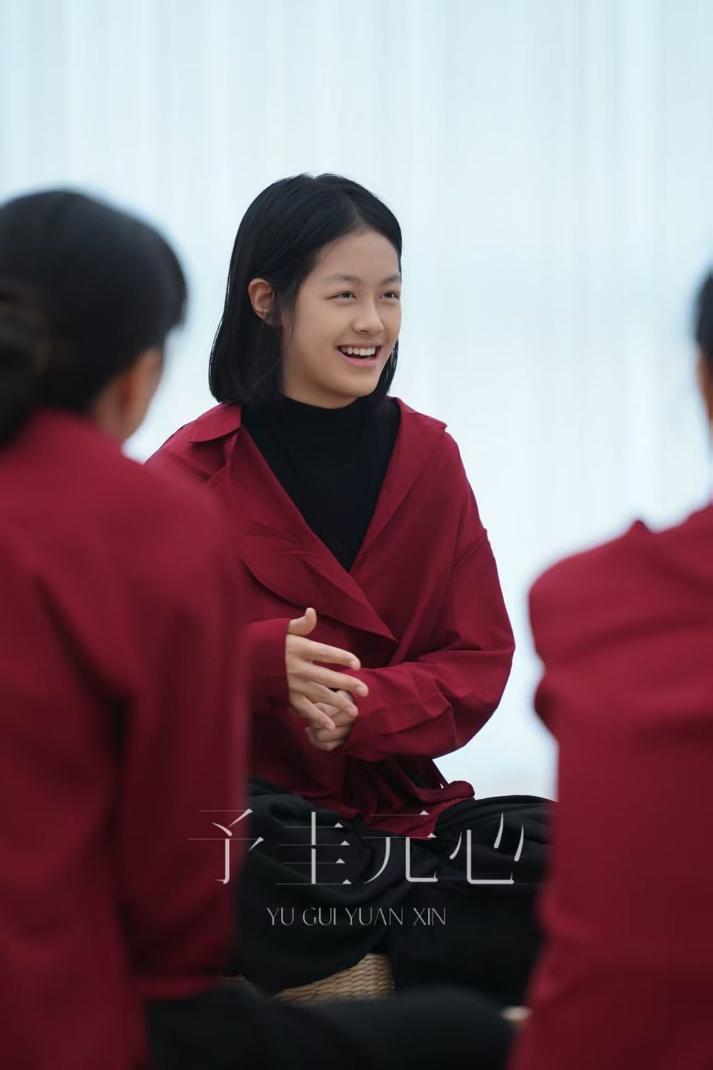 Joanna, smiling, leading a seated group session.