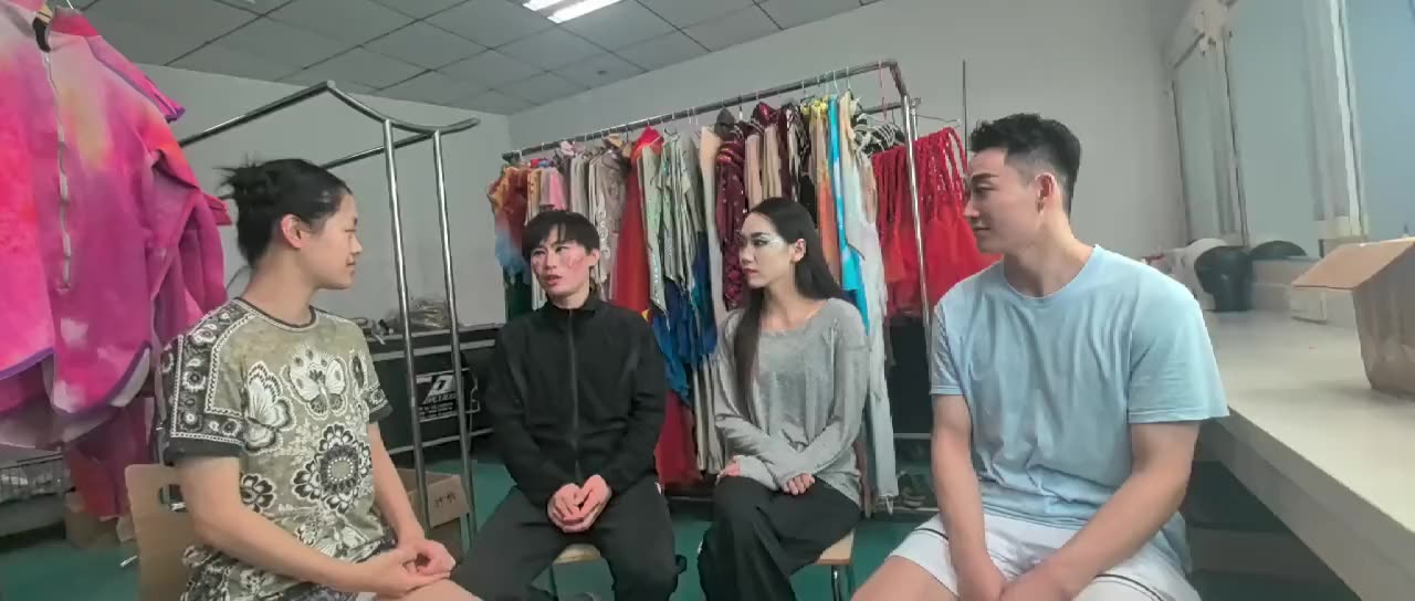Joanna interviewing a group of performers in the wardrobe room of The Han Show Theatre.
